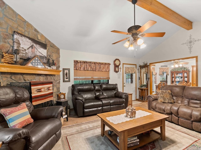 living room with a stone fireplace, ceiling fan, and lofted ceiling with beams