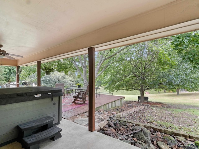 view of patio / terrace featuring ceiling fan, a wooden deck, and a hot tub