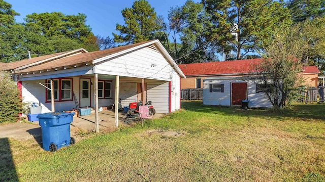 rear view of house with an outdoor structure, a yard, and a porch