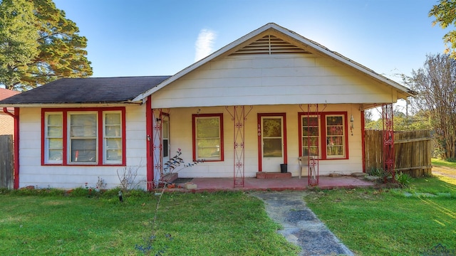 view of front of home with covered porch and a front yard