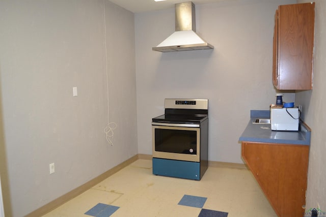 kitchen featuring stainless steel electric stove and wall chimney exhaust hood