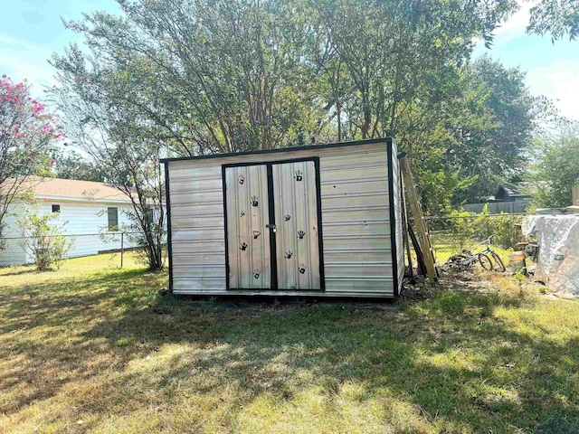 view of outbuilding with a lawn