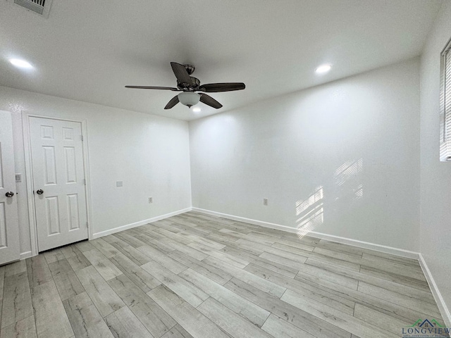 empty room featuring ceiling fan and light hardwood / wood-style flooring