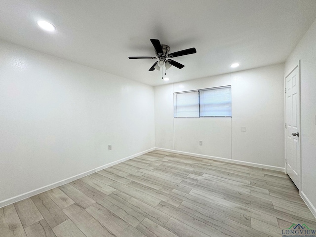 empty room featuring ceiling fan and light hardwood / wood-style floors