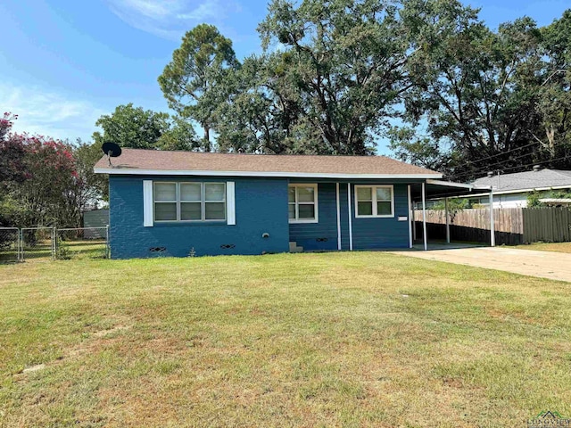 view of front of property with a front lawn and a carport