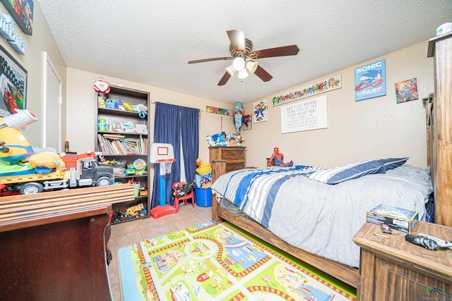 tiled bedroom with a textured ceiling and ceiling fan