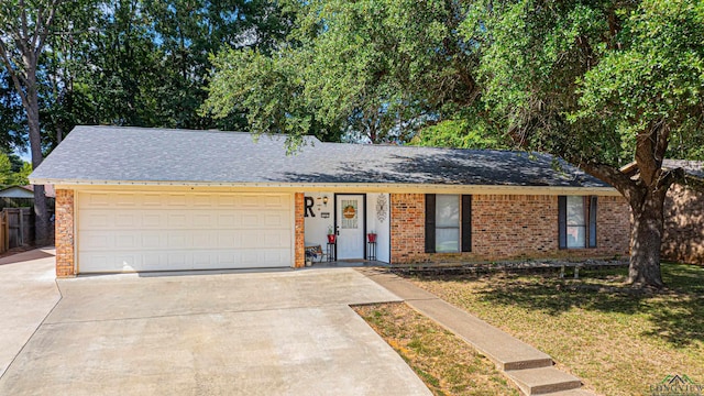 ranch-style home featuring a garage and a front lawn