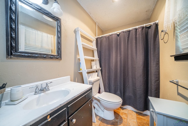 bathroom featuring vanity, a textured ceiling, and toilet