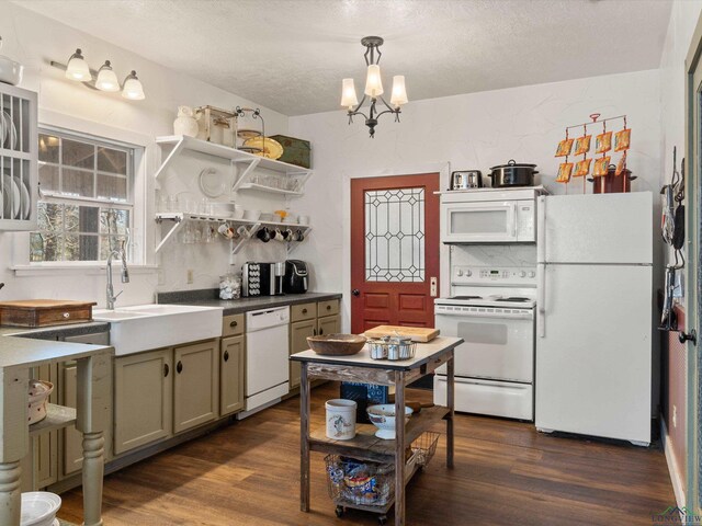 kitchen featuring white appliances, sink, a chandelier, dark hardwood / wood-style floors, and hanging light fixtures