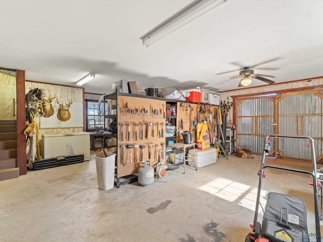 garage featuring a workshop area and ceiling fan