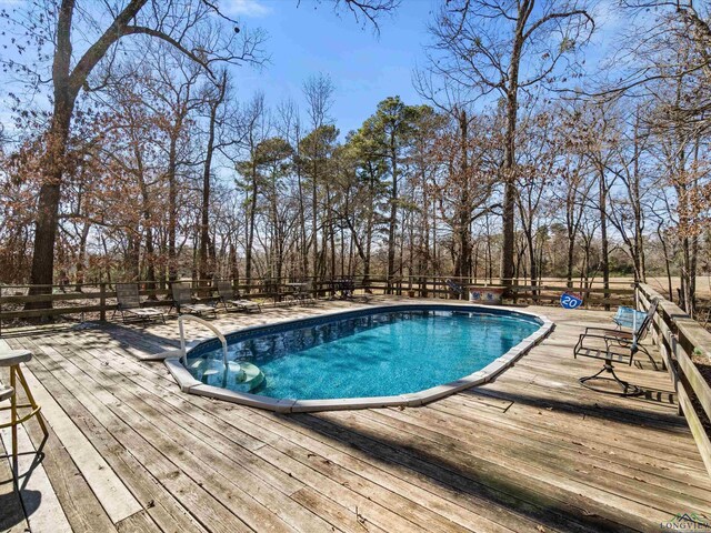 view of swimming pool featuring a deck