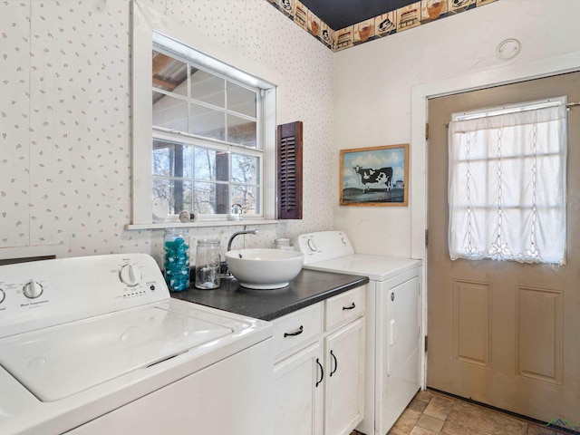 clothes washing area with separate washer and dryer and sink