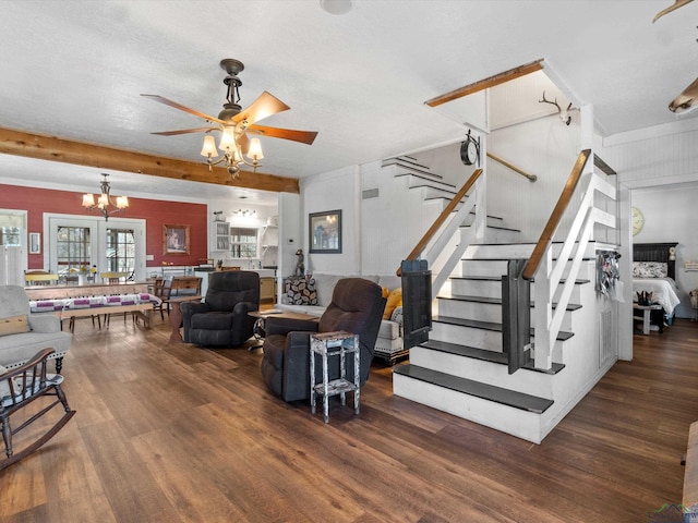 living room featuring beamed ceiling, ceiling fan with notable chandelier, dark hardwood / wood-style floors, and a textured ceiling