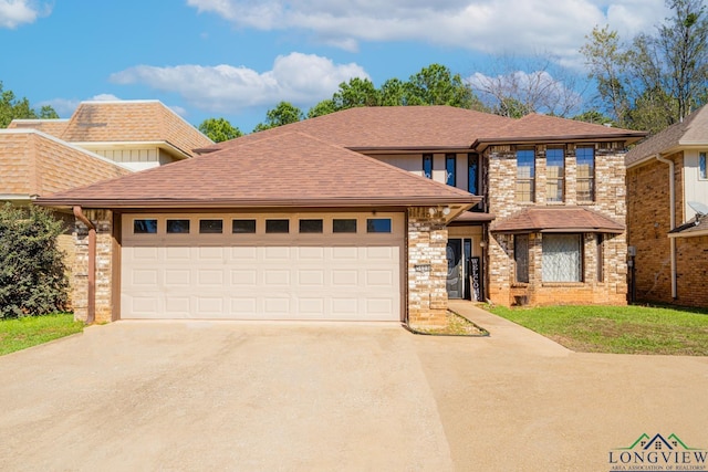 view of front of property with a garage and a front lawn