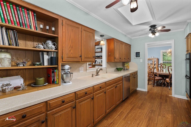 kitchen featuring backsplash, sink, wood-type flooring, decorative light fixtures, and dishwasher