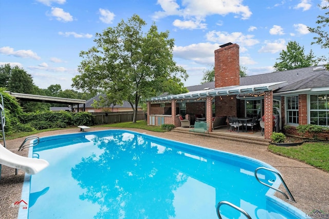 view of pool featuring a patio, a diving board, a pergola, and a water slide