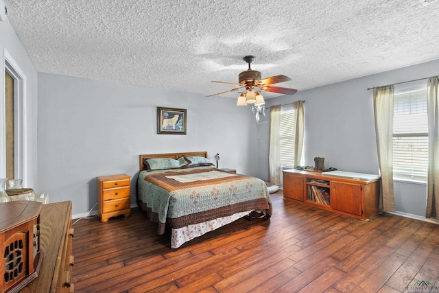3955 E US Highway 79, Henderson, TX 75652 - bedroom featuring wood-type flooring, multiple windows, a textured ceiling, a ceiling fan, and baseboards