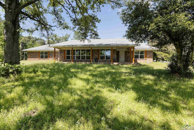 3955 E US Highway 79, Henderson, TX 75652 - rear view of house featuring a yard and brick siding