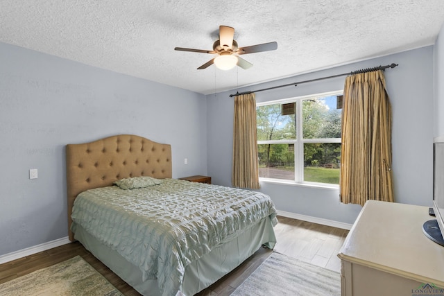 3955 E US Highway 79, Henderson, TX 75652 - bedroom with wood finished floors, baseboards, a textured ceiling, and ceiling fan