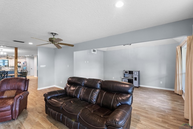 3955 E US Highway 79, Henderson, TX 75652 - living room with a ceiling fan, baseboards, light wood-type flooring, a textured ceiling, and recessed lighting