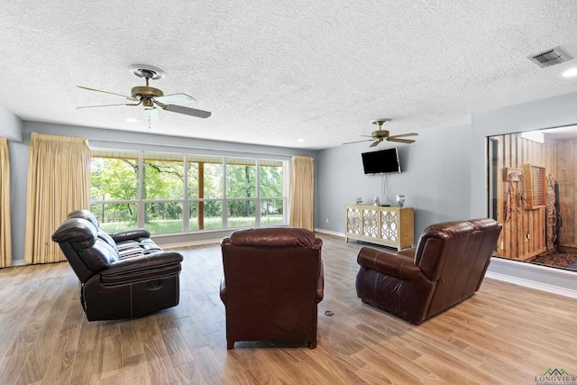 3955 E US Highway 79, Henderson, TX 75652 - living room featuring a ceiling fan, light wood-type flooring, a textured ceiling, and baseboards