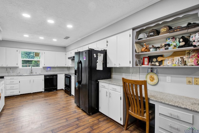 3955 E US Highway 79, Henderson, TX 75652 - kitchen featuring black appliances, a textured ceiling, recessed lighting, a sink, and white cabinets
