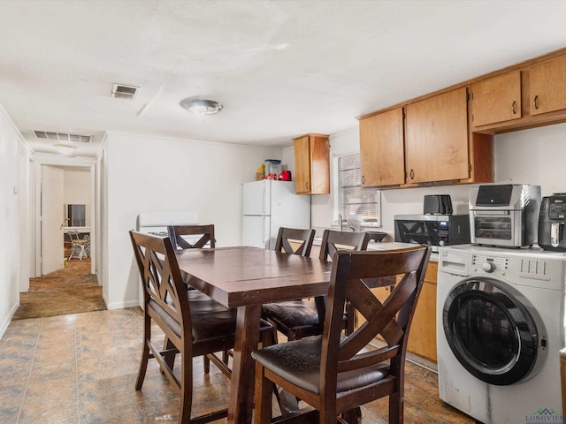 dining room with washer / dryer