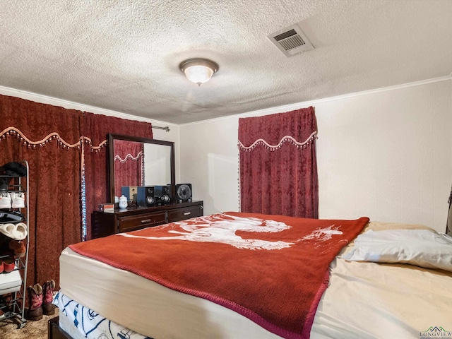 bedroom featuring crown molding and a textured ceiling