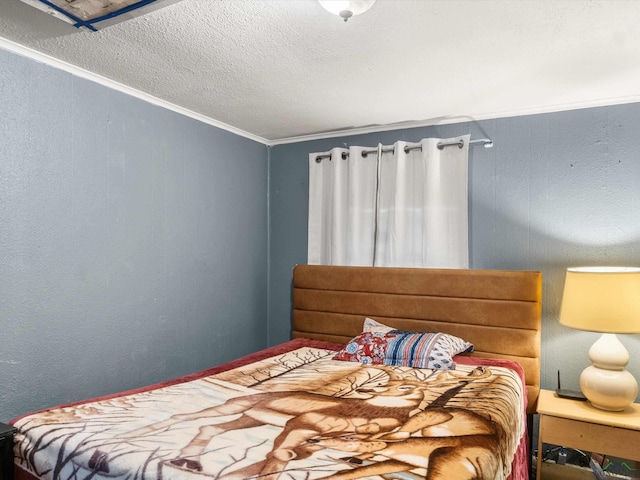 bedroom featuring crown molding and a textured ceiling