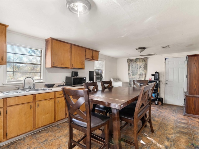 dining area with washer / dryer and sink