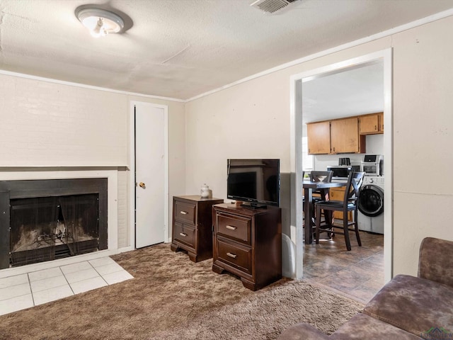 carpeted living room featuring a textured ceiling and washer / clothes dryer