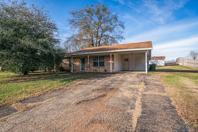 view of front of house with a front yard and a carport