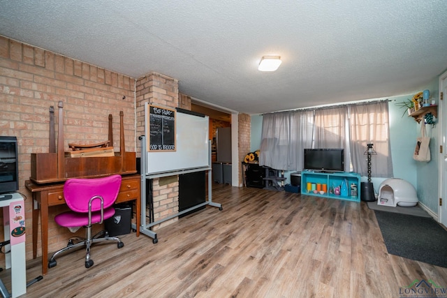 office area with a textured ceiling and hardwood / wood-style floors