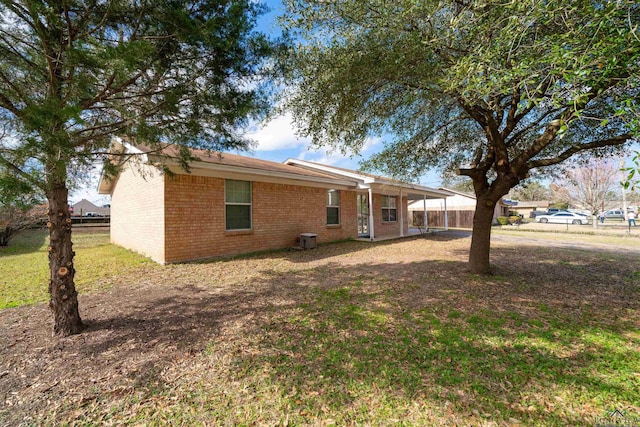 rear view of property featuring a yard