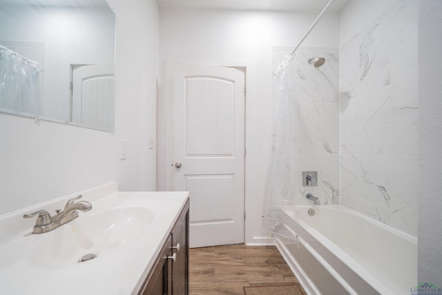 bathroom with hardwood / wood-style floors, vanity, and shower / bath combo with shower curtain