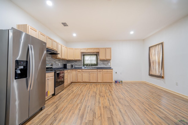 kitchen with backsplash, sink, light wood-type flooring, light brown cabinetry, and appliances with stainless steel finishes