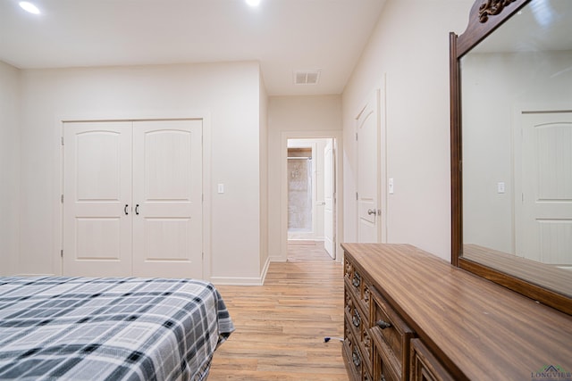 bedroom featuring light hardwood / wood-style floors and a closet