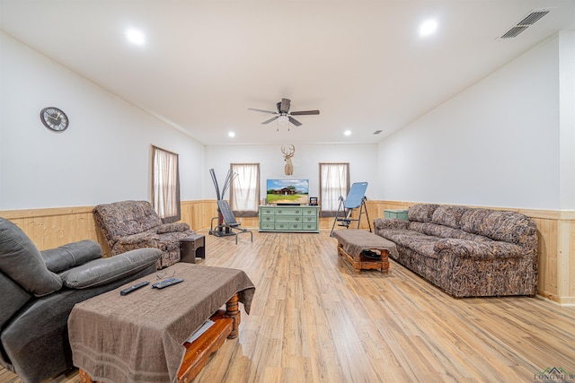 living room with ceiling fan and light hardwood / wood-style floors