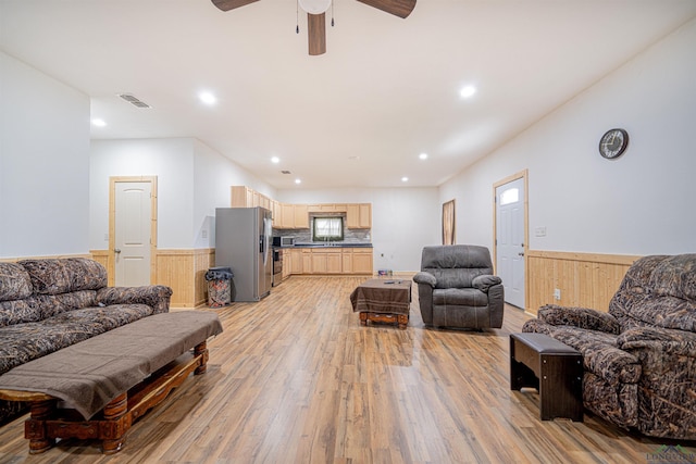 living room featuring ceiling fan and light hardwood / wood-style floors