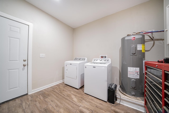 laundry area with washer and dryer, light wood-type flooring, and water heater