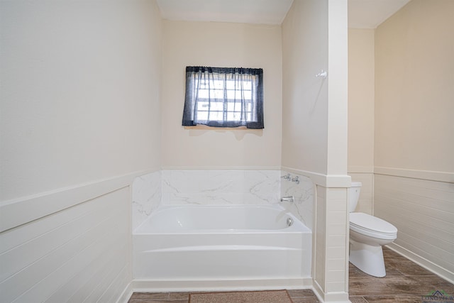 bathroom with toilet and a bathing tub