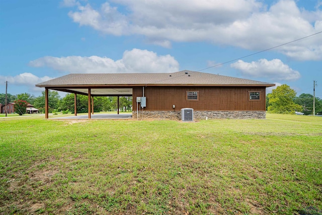 back of house featuring a lawn and central AC