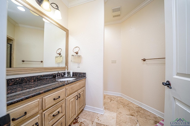 bathroom featuring ornamental molding and vanity