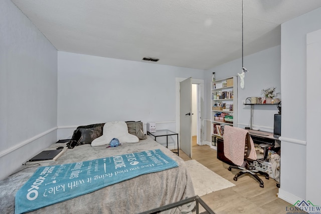 212 W W Ctr, White Oak, TX 75693 - bedroom with wood finished floors and a desk