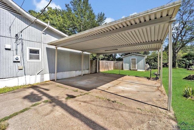 212 W W Ctr, White Oak, TX 75693 - view of parking featuring a storage shed, concrete driveway, and a carport