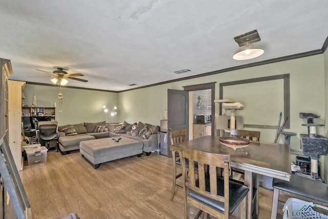 212 W W Ctr, White Oak, TX 75693 - living room featuring crown molding, a ceiling fan, and light wood-style flooring