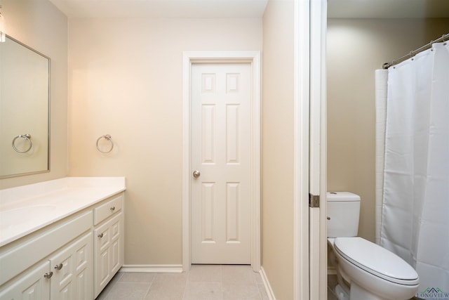 bathroom with vanity, walk in shower, tile patterned floors, and toilet