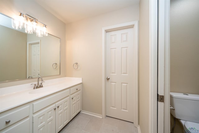 bathroom with vanity, tile patterned flooring, and toilet