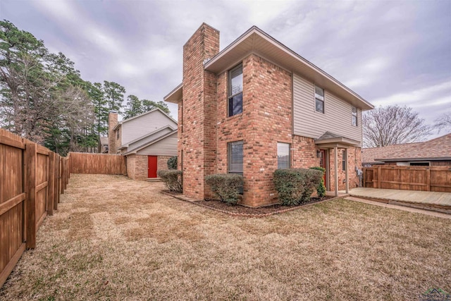 rear view of property featuring a yard and a patio area