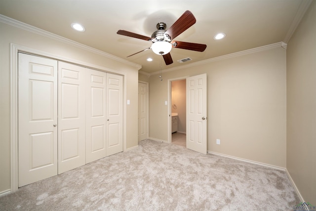 unfurnished bedroom with light carpet, ornamental molding, a closet, and ceiling fan